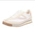 White sneaker with a brown sole on a white background