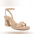 A single nude beige patent leather sandal with a block heel, double front straps, and an ankle strap with a buckle, shown against a white background.
