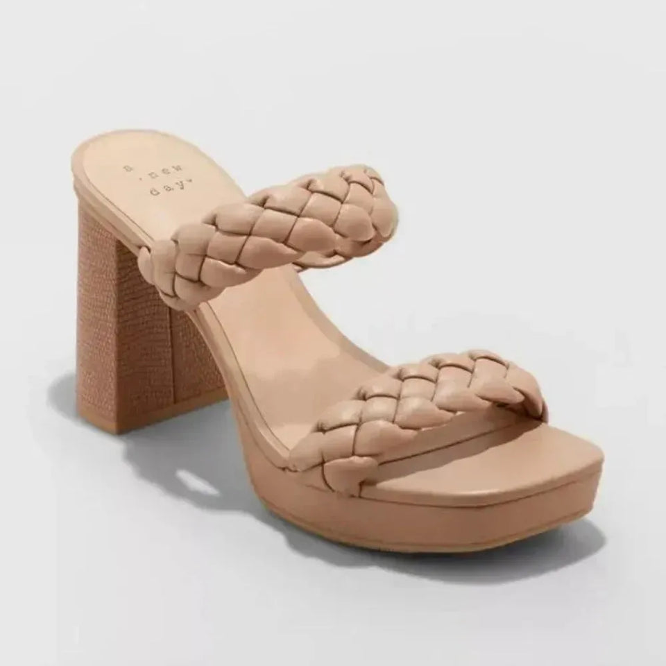 Beige platform sandal with woven design on a light gray background