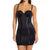 A woman modeling a black shapewear mini dress with underwire cups and vertical seam panels on a plain white background.