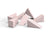 A collection of pink makeup wedges scattered on a white surface.