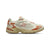 White and orange sneaker with New Balance logo on a white background