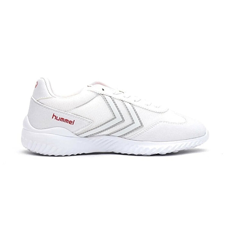 A white Hummel athletic sneaker with textured mesh panels, metallic silver chevron stripes, and a red 'hummel' logo on the side, shown against a plain white background.