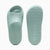 A pair of Puma slide sandals in a light mint green color, shown from both the top and bottom views against a clean white background.