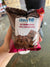 Choc Pop soft brownie cupcake packaging held by a hand on a blurred background
