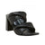 Black heeled sandal with woven design on a white background