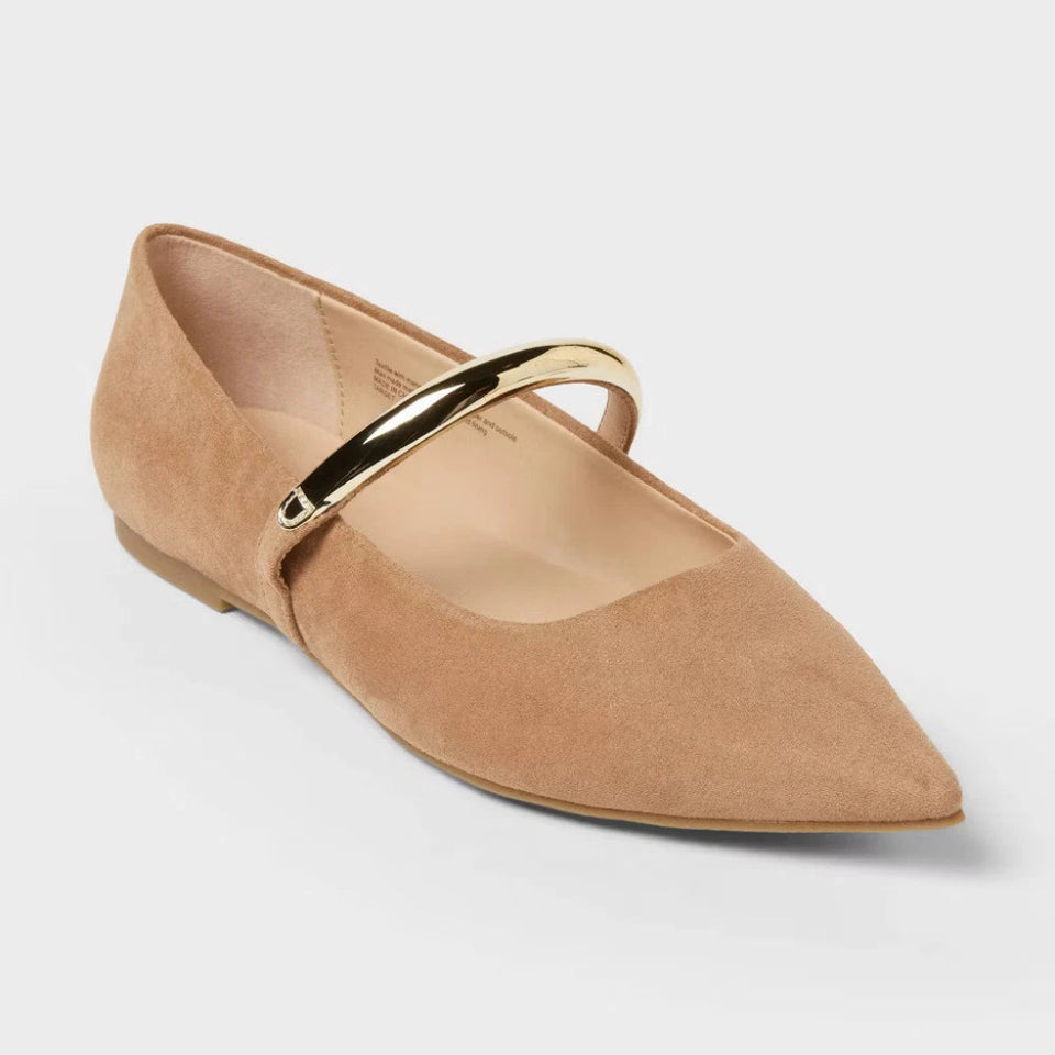 Beige flat shoe with a gold strap on a light gray background