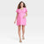 Woman wearing a pink dress on a white background