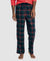 Person wearing dark green plaid pajama pants on a white background