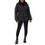 A woman modeling a black hooded puffer jacket with horizontal quilting, black leggings, and black ankle boots against a plain white background.