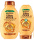 Two bottles of Garnier Ultra Doux Honey Treasures Shampoo and Conditioner, with honey-themed design on the labels.