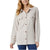 A woman wearing a light beige long-sleeve button-up shirt jacket with two chest pockets and brown buttons, paired with blue jeans, against a plain white background.