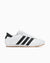 White sneaker with black stripes on a white background
