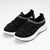 Black sneakers with white soles on a light gray background