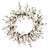 A circular artificial floral wreath featuring white blossoms on dark brown branches, isolated on a solid white background.