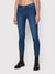 Person wearing blue jeans and black boots on a white background