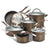 A 12-piece stainless steel cookware set in a bronze finish, including pots, sauté pans, a deep skillet, and lids, arranged on a white background.