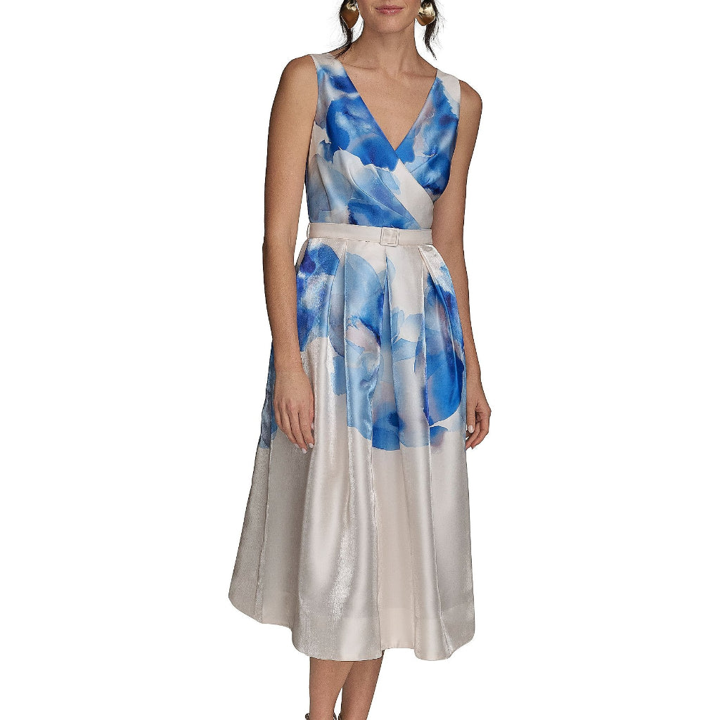 A sleeveless midi dress with a blue and white abstract watercolor print, featuring a V-neckline, a defined waist, and a flared skirt, modeled on a plain white background.