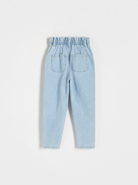 Light blue denim pants on a white background