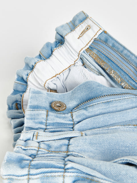 Stack of light blue denim shorts on a white background