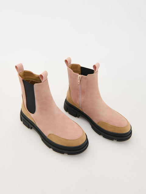 Pair of pink and beige Chelsea boots on a white background