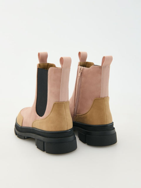 Pair of pink and brown boots with black soles on a white background