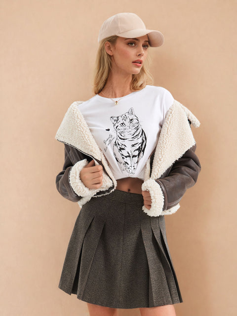 Woman wearing a white t-shirt with a tiger design, gray jacket with white fur lining, and pleated gray skirt on a beige background.