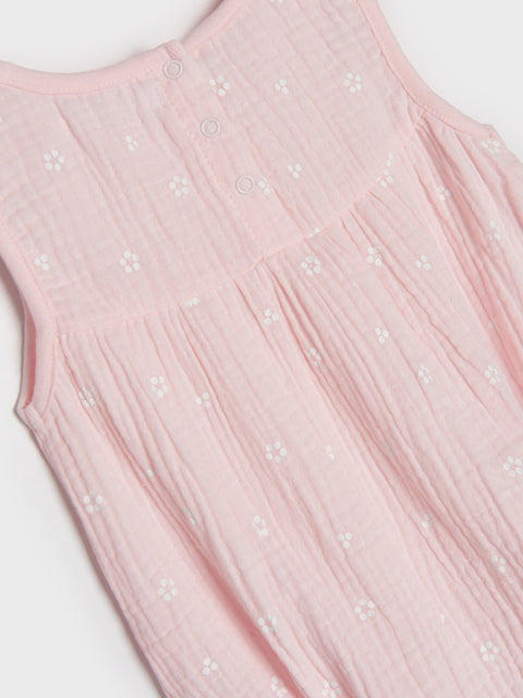 Pink sleeveless dress with floral embellishments on a white background