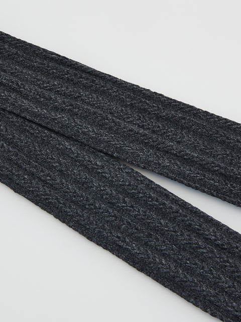 Two dark gray shoelaces on a light gray background