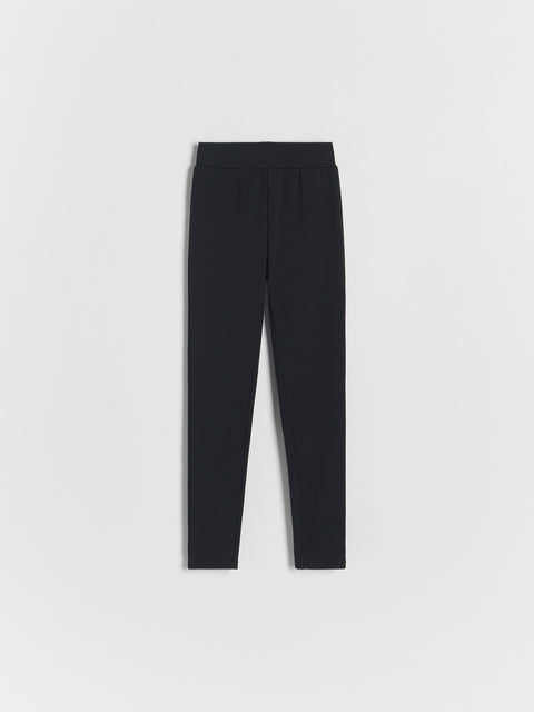 Black leggings on a light gray background