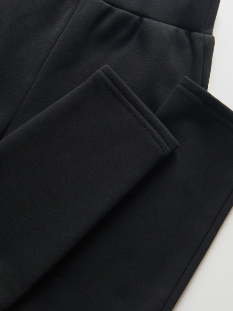 Close-up of black pants on a white background