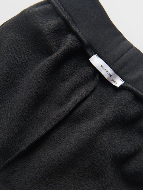 Black fabric with a visible label on a white background