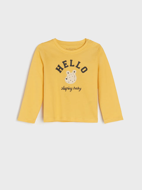 Yellow long-sleeve shirt with 'HELLO' and bear graphic on a white background