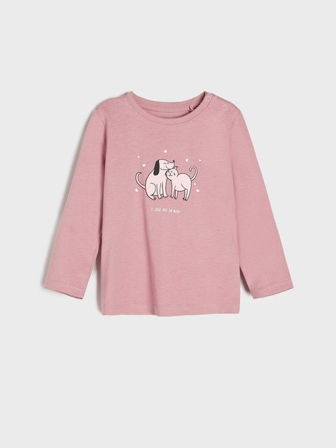 Pink long-sleeve shirt with dog graphic on a light gray background