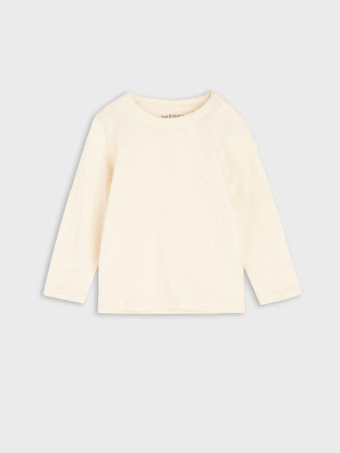 Cream-colored long-sleeve shirt on a light gray background
