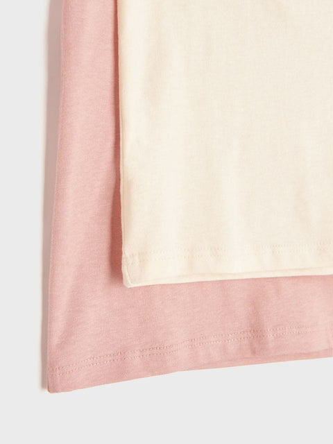 Close-up of a pink and beige fabric border on a white background