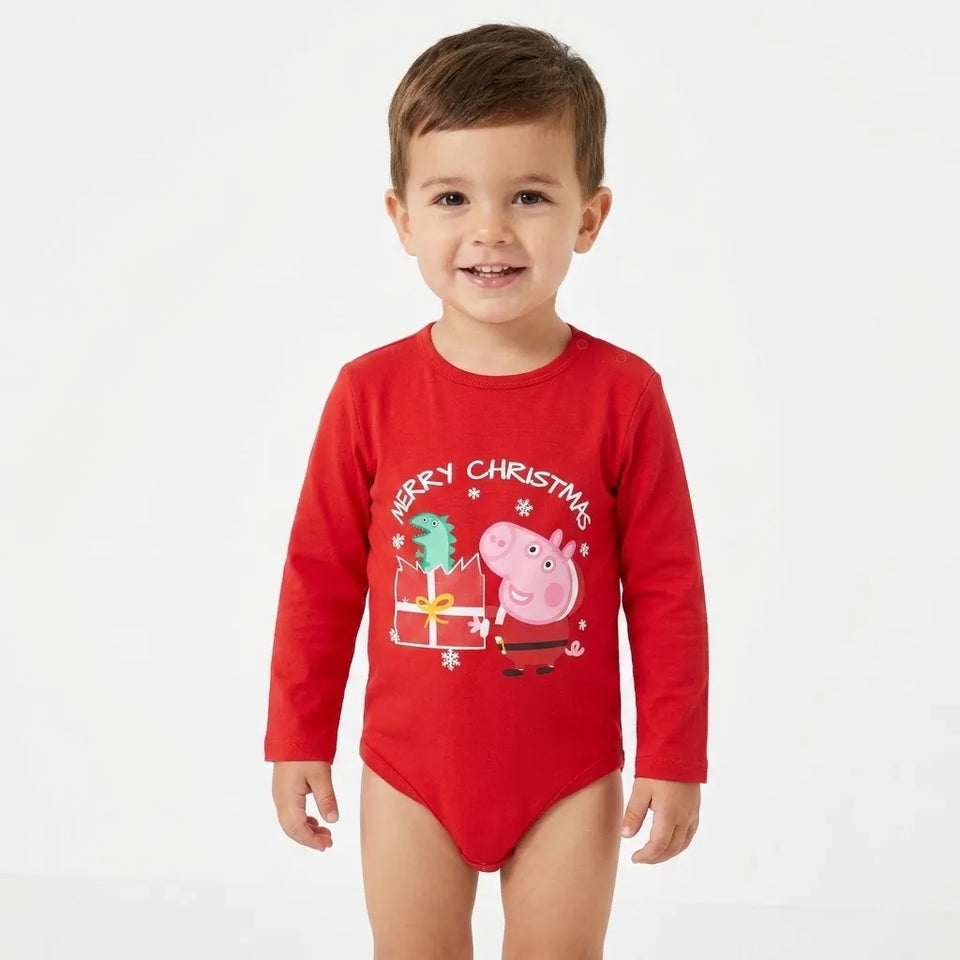 A young child wearing a red long-sleeve bodysuit with a 'Merry Christmas' Peppa Pig graphic on the front, standing against a plain white background.