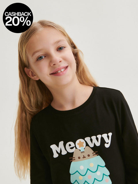 Young girl wearing a black sweatshirt with 'Meowy' and a cat graphic on a plain background
