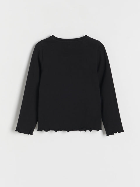Black sweater with scalloped hem on a white background