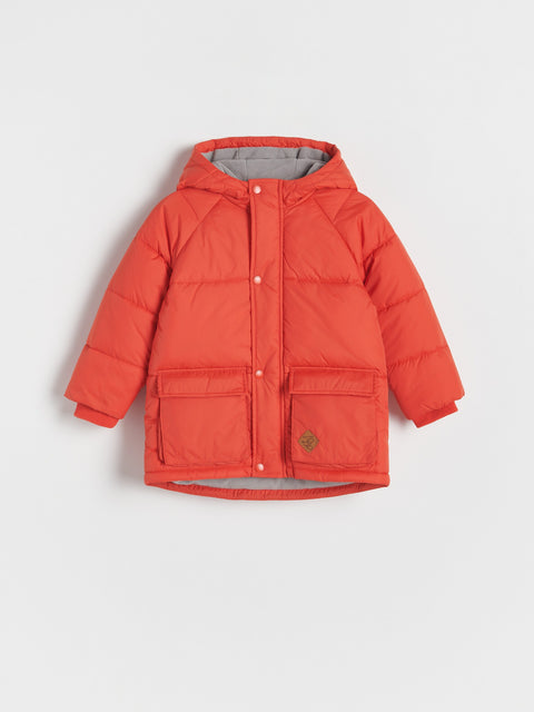 Red puffer jacket on a light gray background