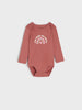 Pink baby bodysuit with text and rainbow design on a white background