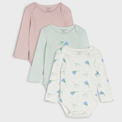 Three baby bodysuits in pink, green, and white with floral pattern on a light gray background