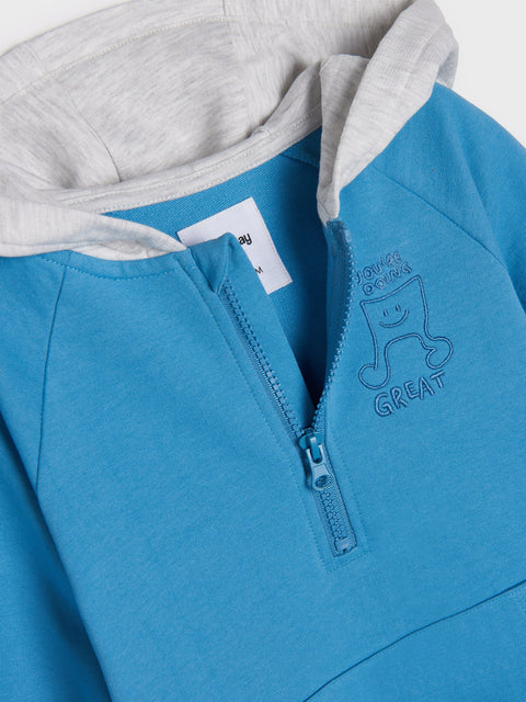 Blue hoodie with a logo and text on a white background