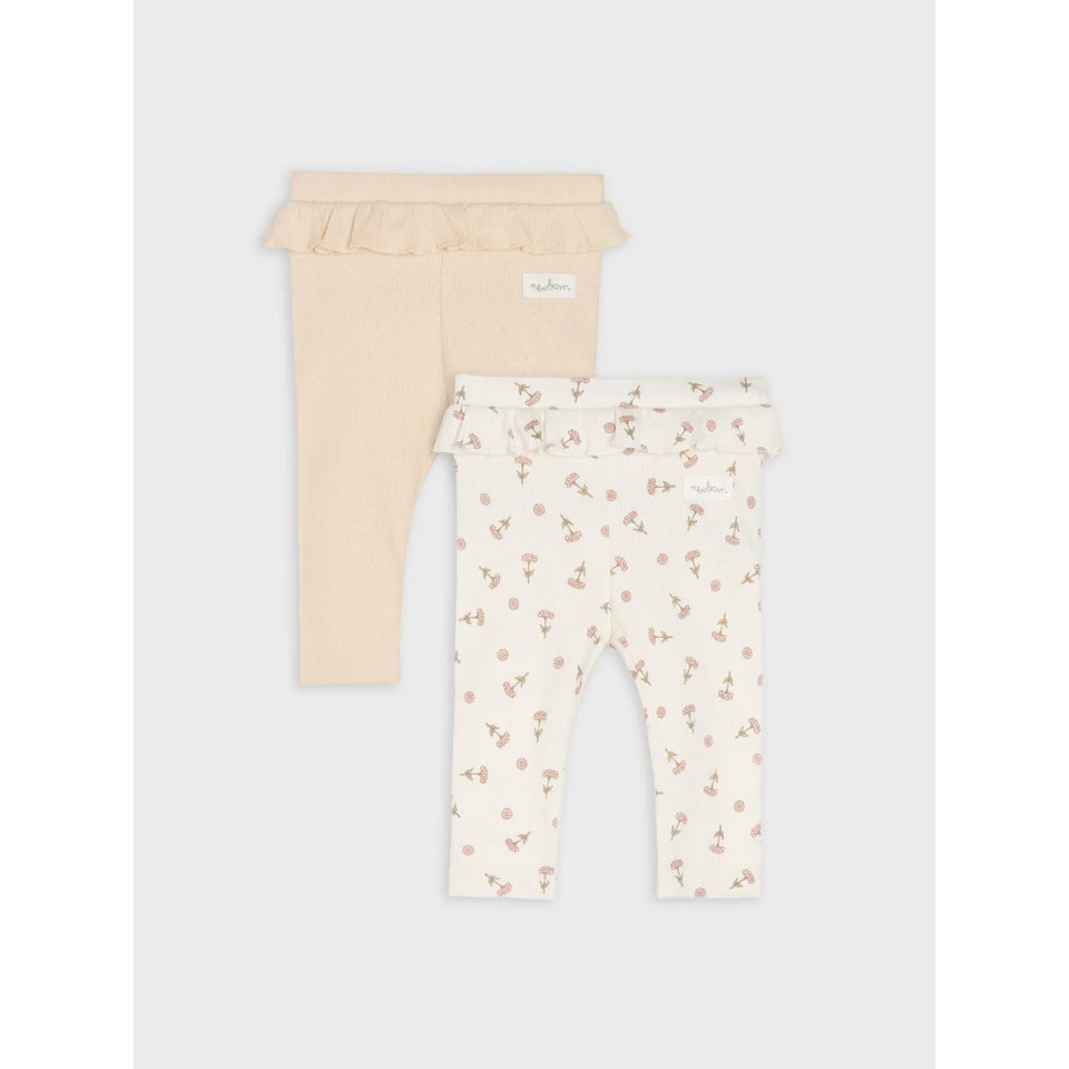 Two pairs of baby leggings from the brand 'big louise' shown on a light gray background. One pair is a solid pale peach-beige color with a ruffled waistband, and the other is cream with a small pink floral pattern and a ruffled waistband.