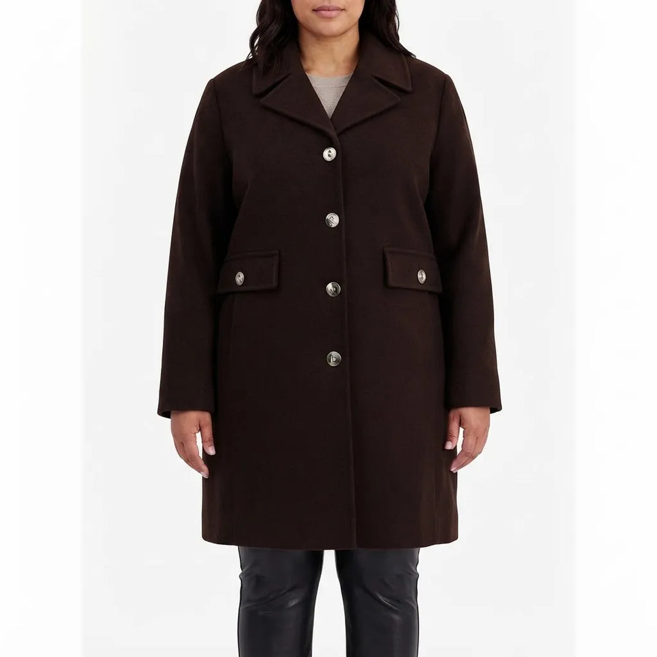 A woman wearing a dark brown wool-blend coat with silver-tone buttons and flap pockets, paired with black leather pants, against a plain white studio background.