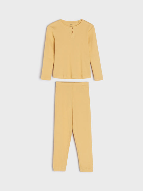 Yellow pajama set with top and pants on a white background
