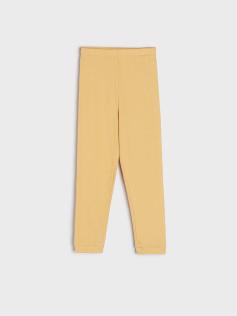 Mustard yellow leggings on a white background