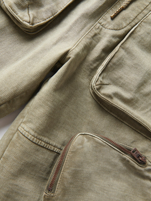 Close-up of a beige jacket with zippers and buttons