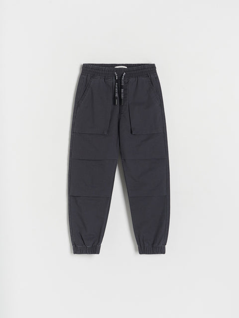 Dark gray jogger pants on a light gray background