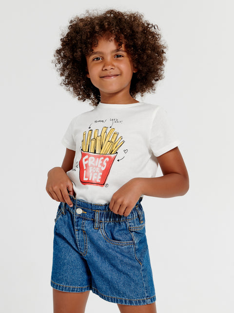 Child wearing a white t-shirt with a French fries graphic and blue shorts on a light gray background